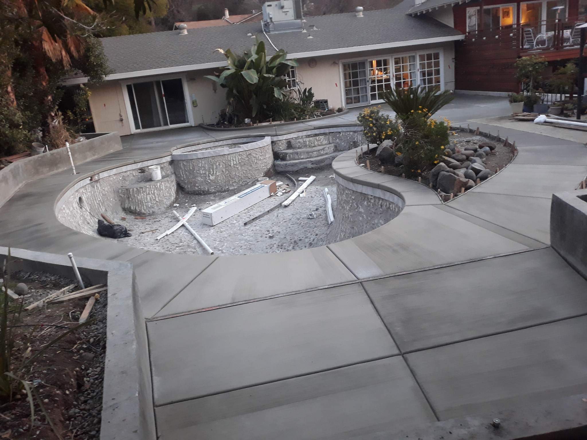Concrete patio and curved planter under construction